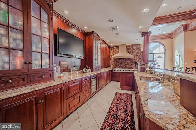 kitchen with visible vents, ornamental molding, a sink, wine cooler, and wall chimney exhaust hood