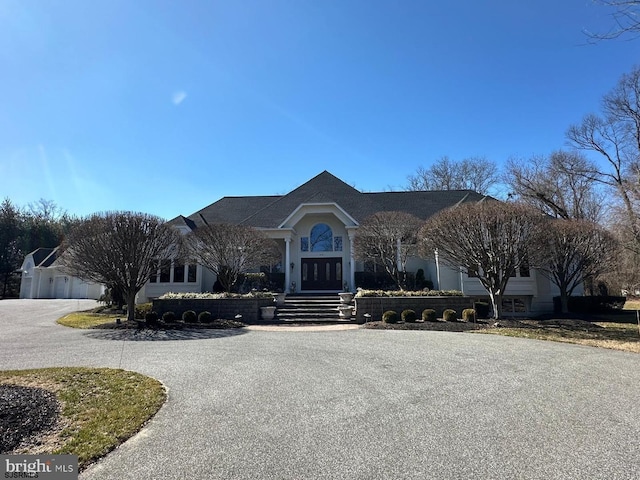 view of front of home featuring french doors and curved driveway