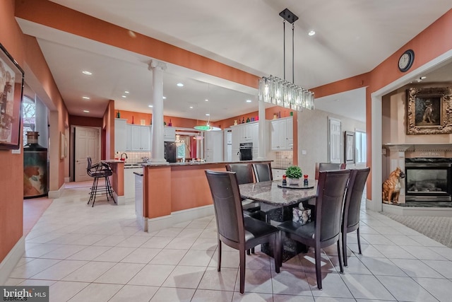 dining space with light tile patterned floors, a multi sided fireplace, recessed lighting, and baseboards