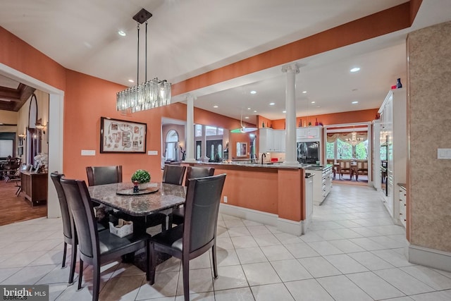 dining room featuring recessed lighting, light tile patterned flooring, and ornate columns