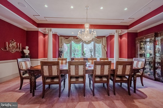 dining space featuring a wainscoted wall, an inviting chandelier, a tray ceiling, and ornamental molding