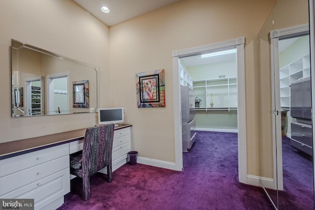 office space with recessed lighting, baseboards, dark colored carpet, and built in study area