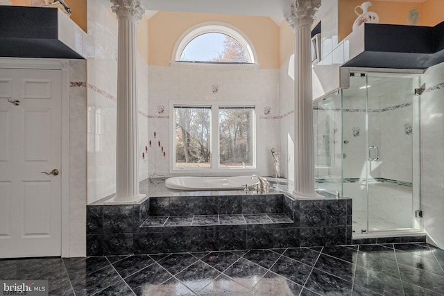 bathroom with a garden tub, a shower stall, and ornate columns