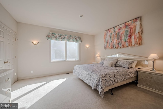 carpeted bedroom featuring baseboards