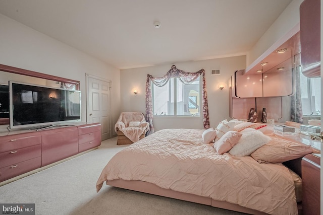 carpeted bedroom with visible vents