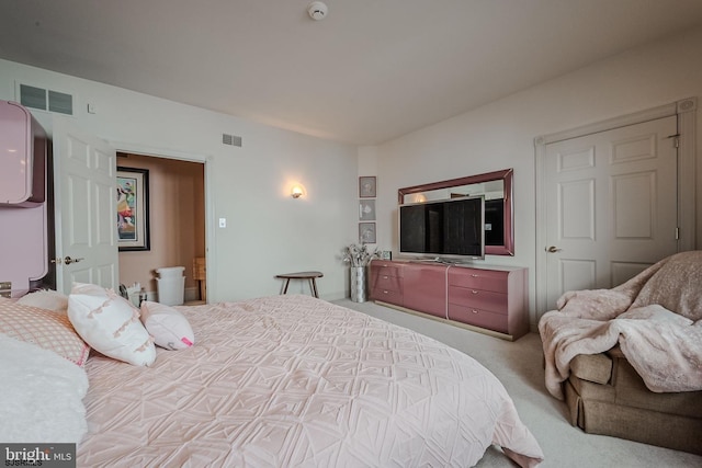 bedroom with visible vents and carpet flooring