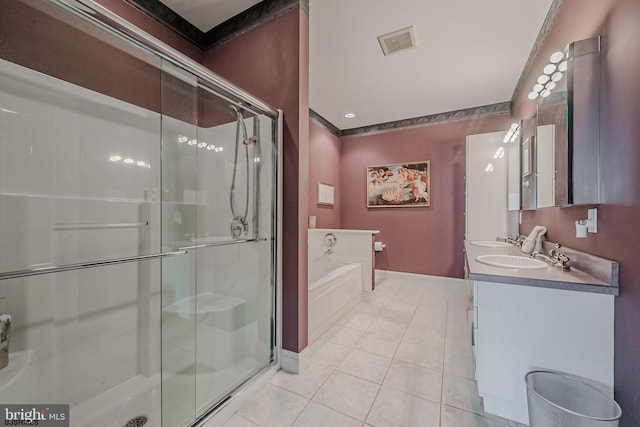 bathroom featuring visible vents, a stall shower, a sink, tile patterned flooring, and a garden tub