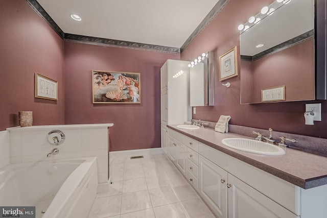 bathroom with tile patterned floors, a garden tub, double vanity, and a sink