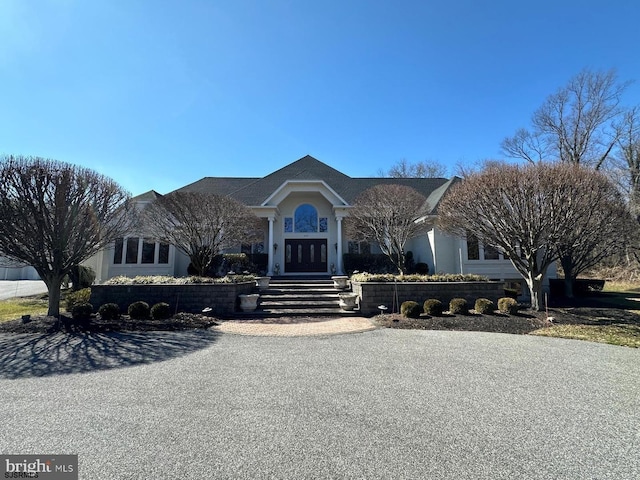 view of front of house with stucco siding and french doors