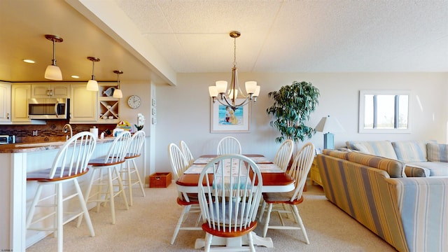 dining room with a notable chandelier, light colored carpet, and recessed lighting