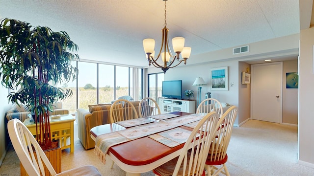 dining space featuring a notable chandelier, visible vents, a textured ceiling, and baseboards