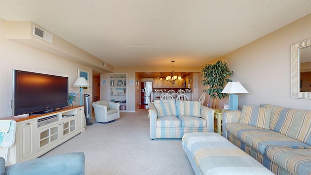 carpeted living area featuring visible vents and an inviting chandelier