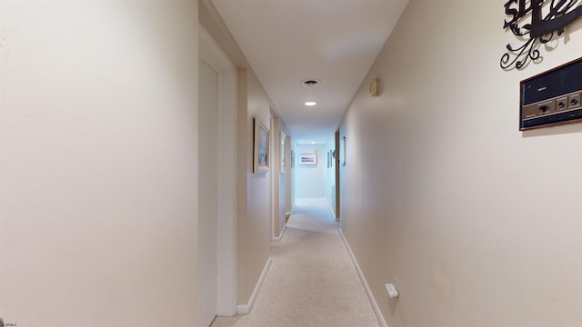 hall featuring recessed lighting, visible vents, baseboards, and light carpet