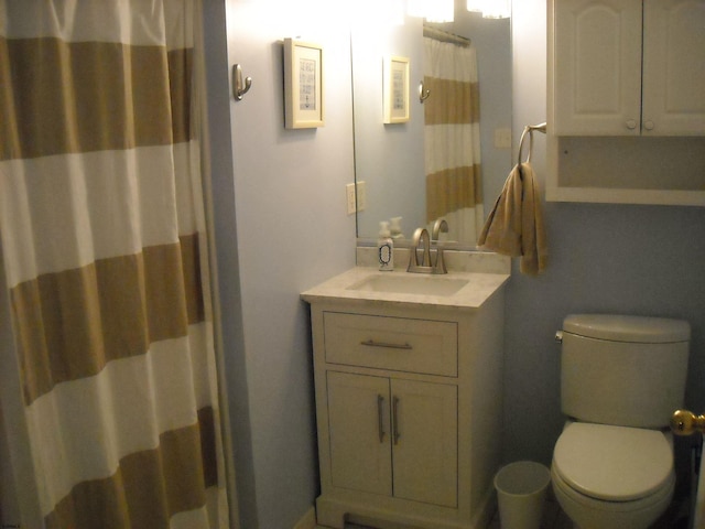 bathroom featuring toilet and vanity