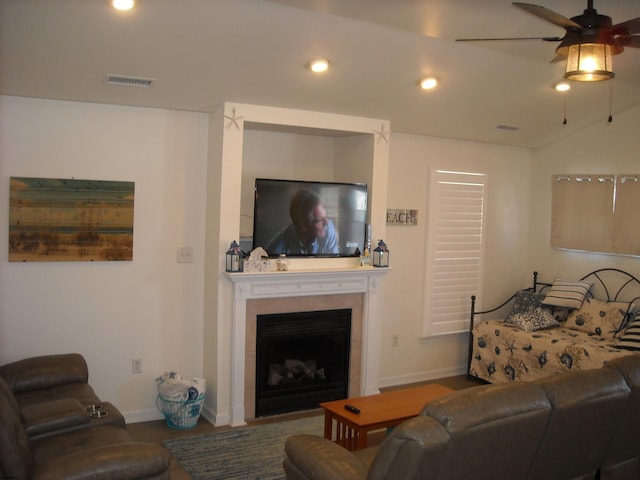 living area featuring visible vents, vaulted ceiling, recessed lighting, a fireplace, and a ceiling fan