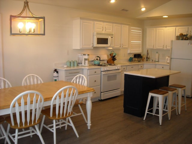 kitchen with white appliances, white cabinets, light countertops, and a sink