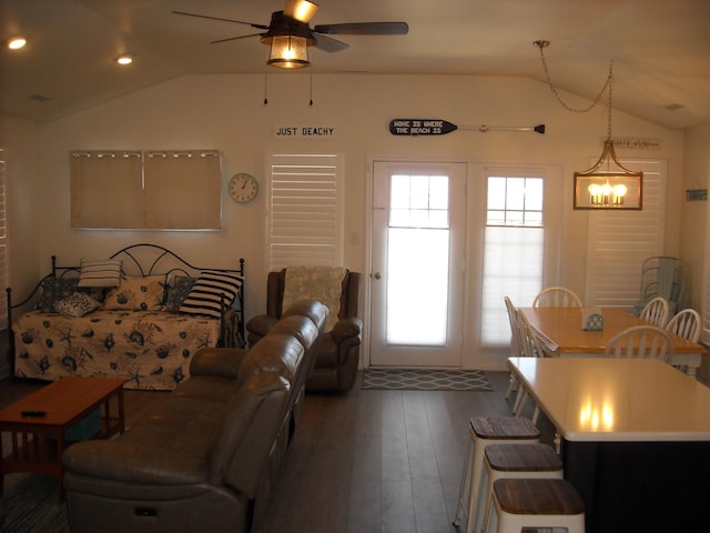 living area with ceiling fan, lofted ceiling, and hardwood / wood-style flooring