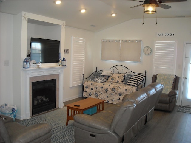 living room featuring ceiling fan, lofted ceiling, recessed lighting, a fireplace, and wood finished floors