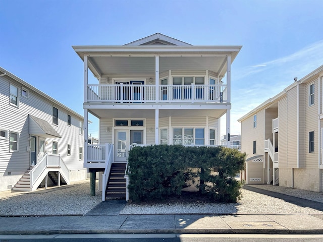 view of front of house featuring stairway and a porch