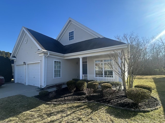 view of front of home with a porch, concrete driveway, a garage, and a shingled roof