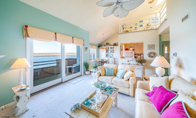 carpeted living area with high vaulted ceiling, visible vents, a water view, and ceiling fan