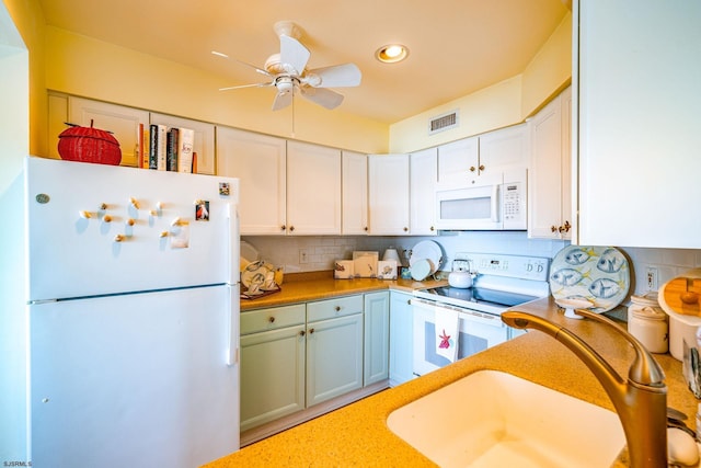 kitchen with white cabinetry, white appliances, backsplash, and a sink