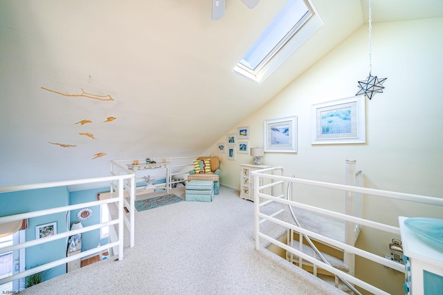 recreation room with carpet floors and lofted ceiling with skylight