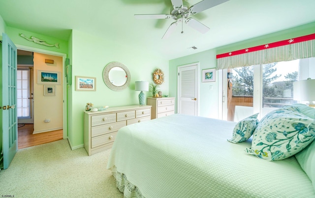 bedroom featuring visible vents, multiple windows, baseboards, and ceiling fan