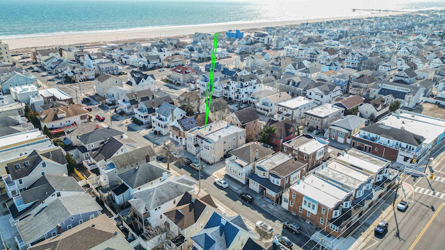 birds eye view of property with a residential view, a view of the beach, and a water view