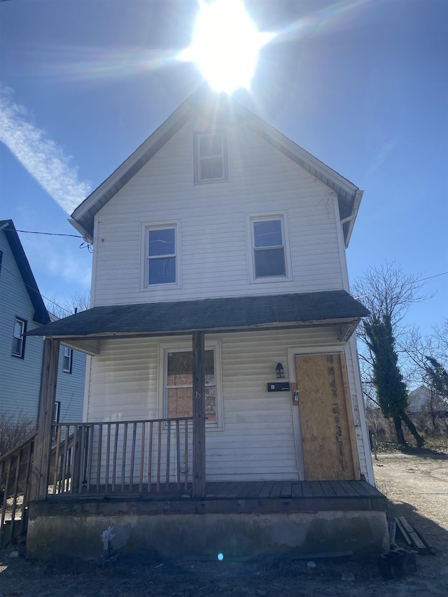 american foursquare style home with covered porch