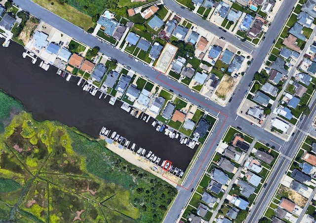 birds eye view of property featuring a water view and a residential view