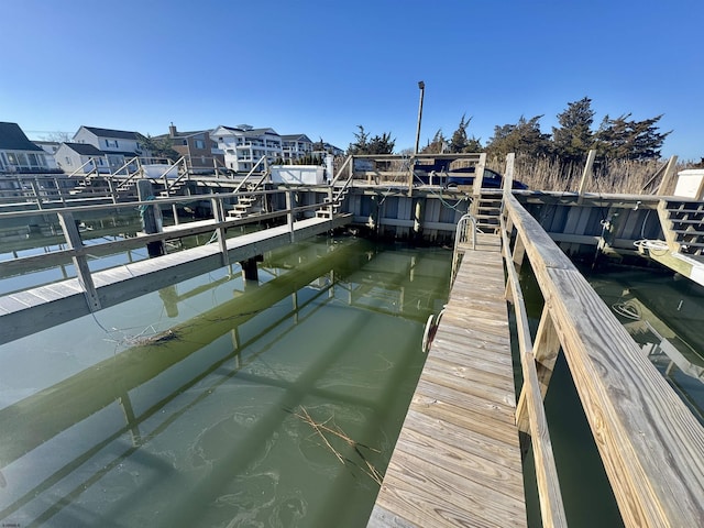 dock area with a residential view and a water view