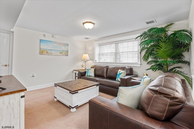 living area featuring light colored carpet, visible vents, and baseboards