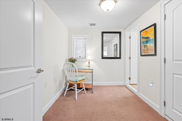 home office with light colored carpet, visible vents, and baseboards