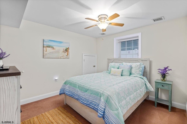 carpeted bedroom with a ceiling fan, baseboards, and visible vents