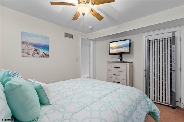 bedroom featuring visible vents, carpet floors, and ceiling fan