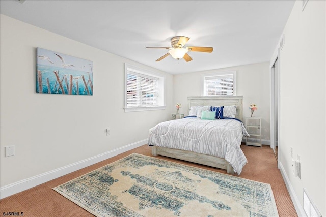 carpeted bedroom featuring baseboards and a ceiling fan