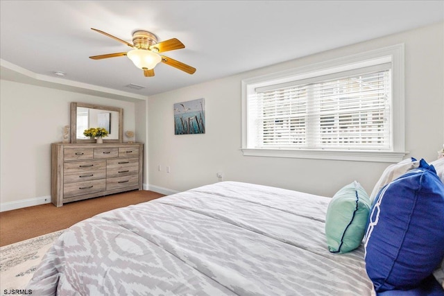 bedroom with visible vents, baseboards, carpet, and a ceiling fan