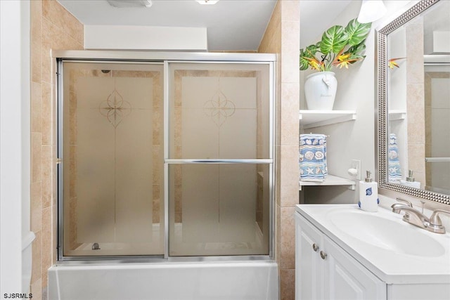 bathroom with combined bath / shower with glass door and vanity