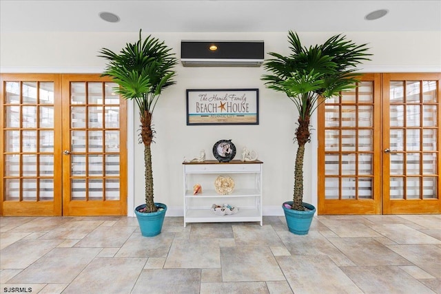 interior space with stone finish flooring, french doors, and a wall mounted AC