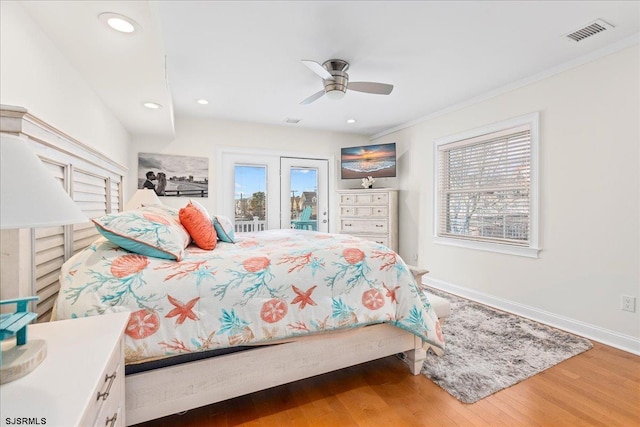 bedroom featuring wood finished floors, visible vents, baseboards, recessed lighting, and access to outside