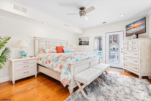 bedroom with visible vents, light wood-style floors, and access to outside