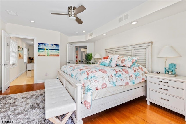 bedroom with recessed lighting, wood finished floors, and visible vents