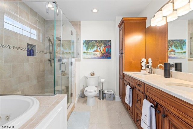 bathroom with tile patterned flooring, a shower stall, and a sink