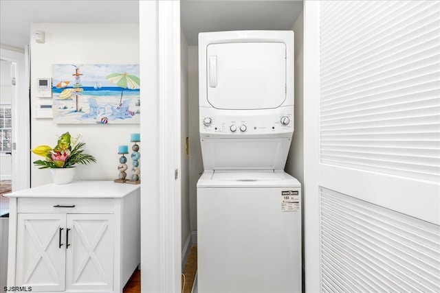 washroom featuring stacked washer and dryer and laundry area