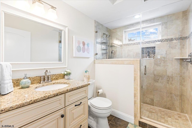 bathroom with vanity, toilet, a shower stall, and tile patterned flooring