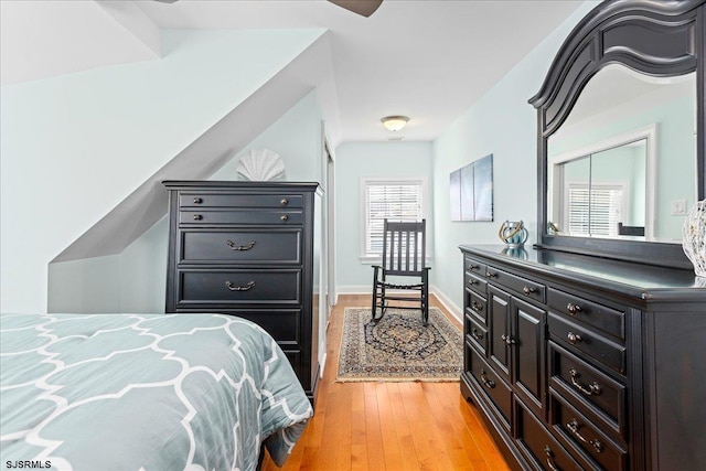 bedroom with light wood-style flooring and baseboards