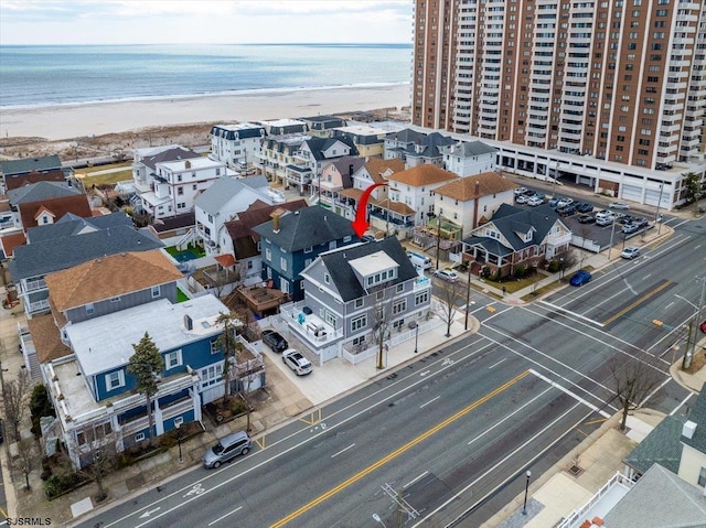 aerial view with a water view and a view of the beach