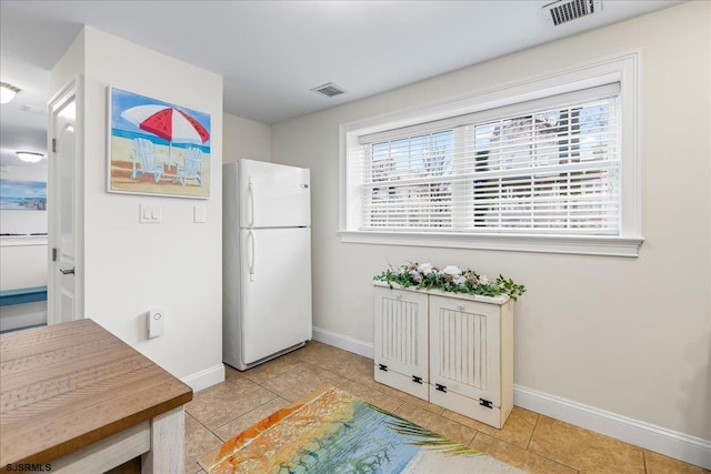 interior space featuring plenty of natural light, visible vents, and freestanding refrigerator