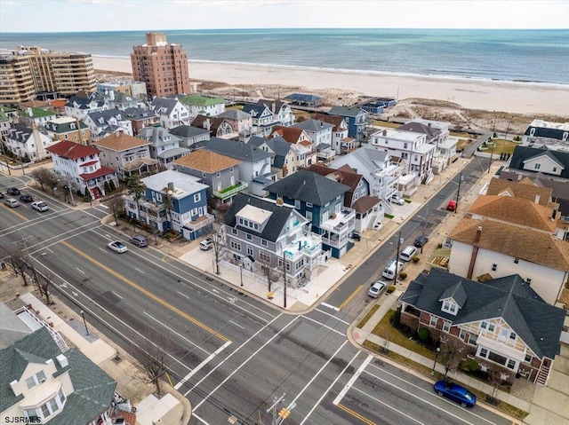 birds eye view of property with a view of the beach and a water view